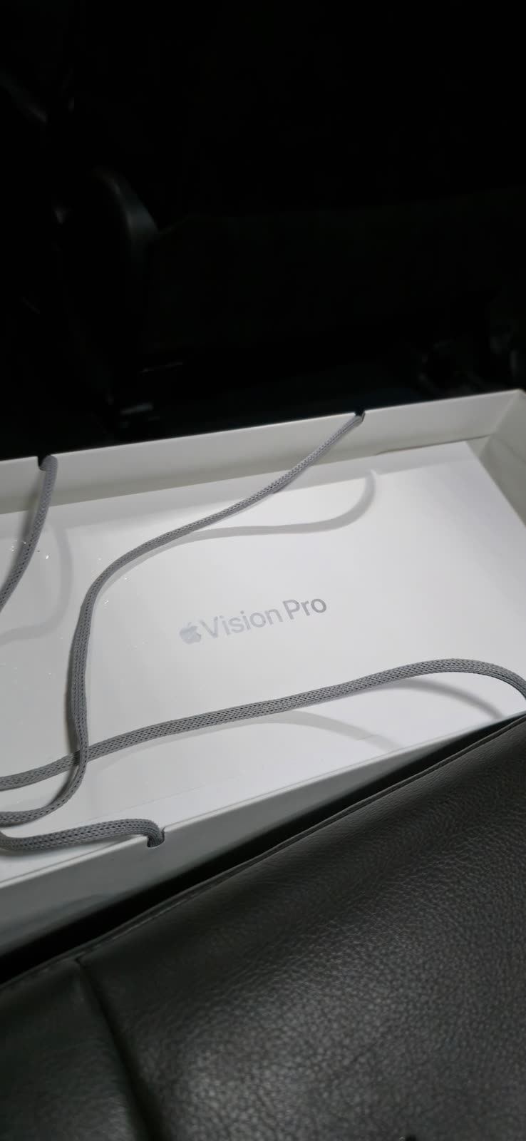 Apple Vision Pro headset box open inside a car