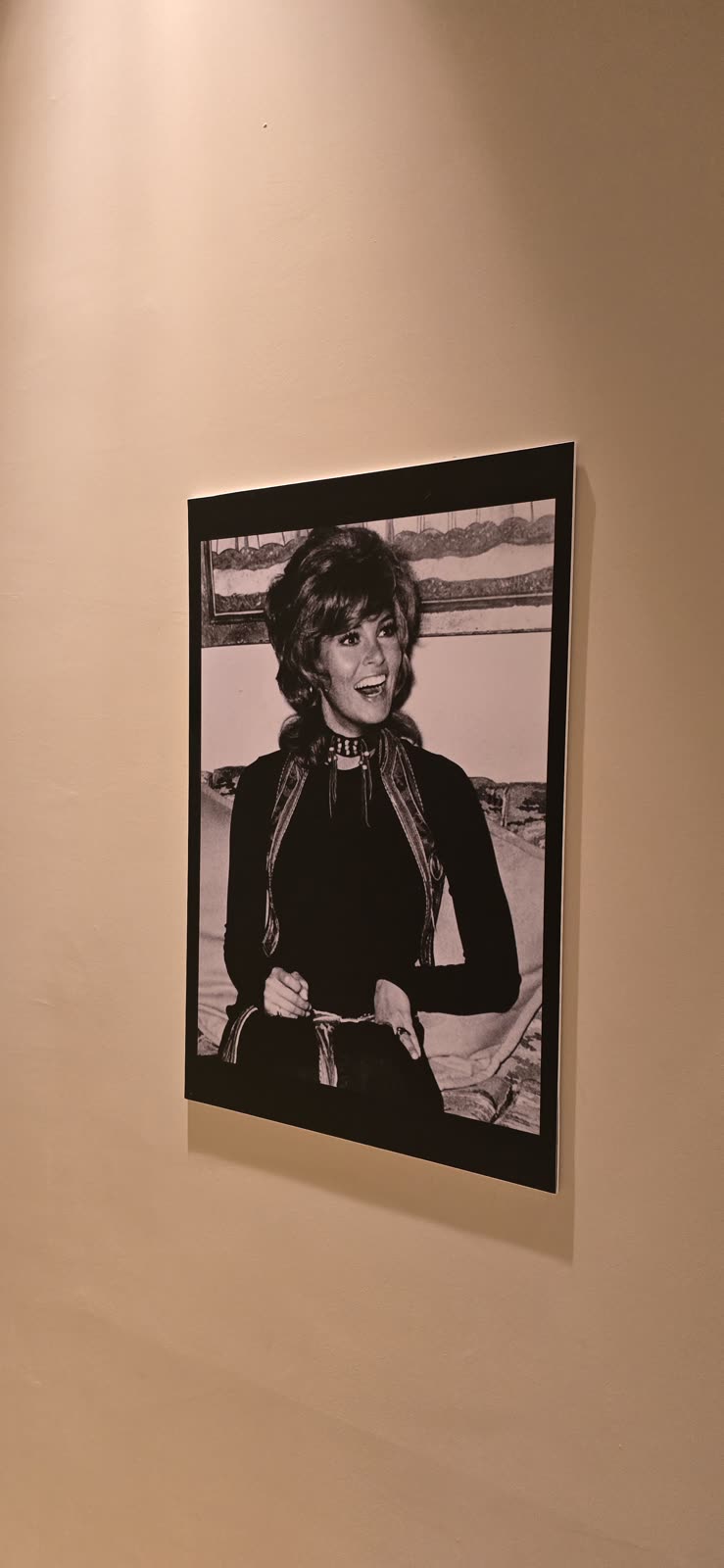 framed black and white portrait photograph on a wall, hotel exhibit
